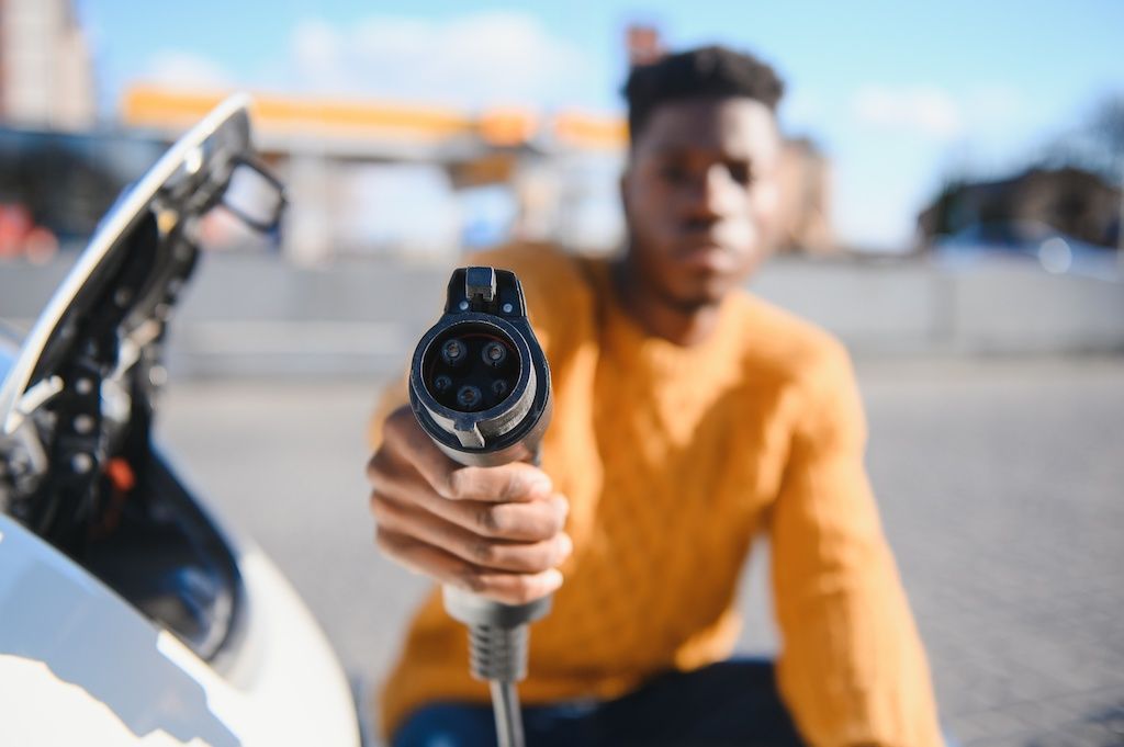 african-american-man-charging-his-electric-car.jpg