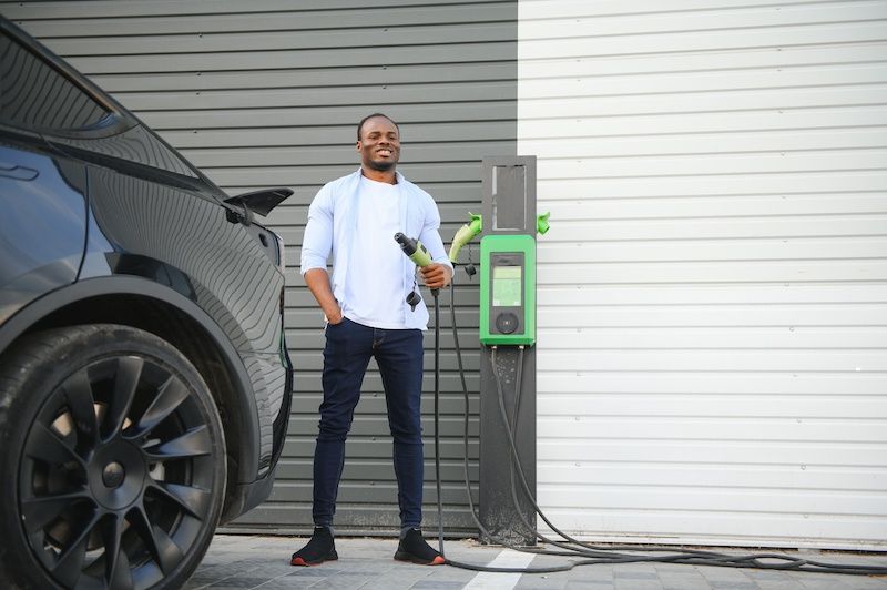 african-american-man-charging-his-electric-car-at-home.jpg