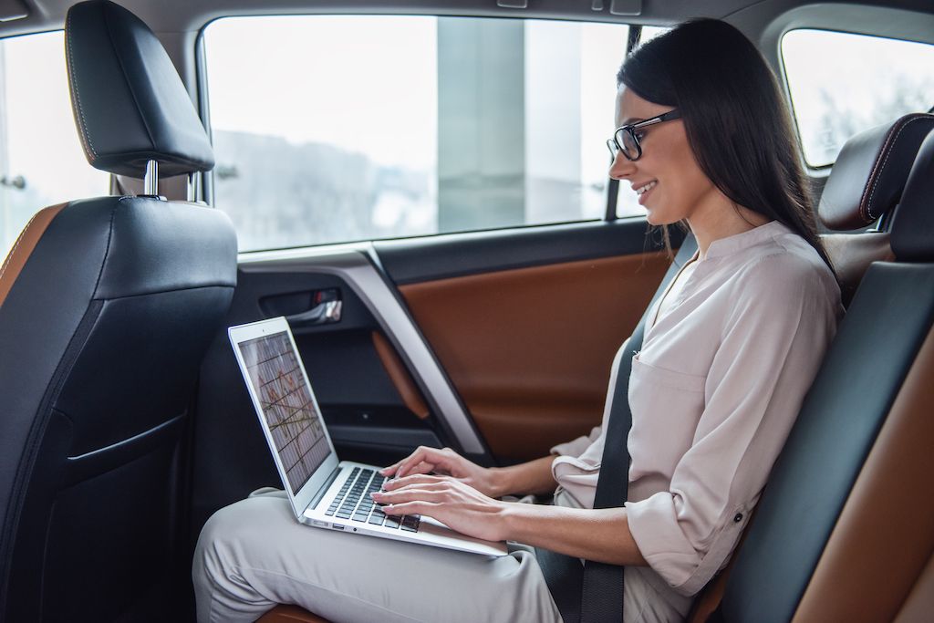 business-woman-in-car-working-on-laptop.jpg