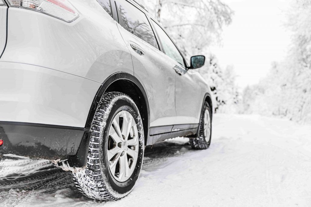 car-tire-on-a-winter-road-in-snow-covered-forest-2022-01-24-18-31-50-utc-min-1024x683.jpg