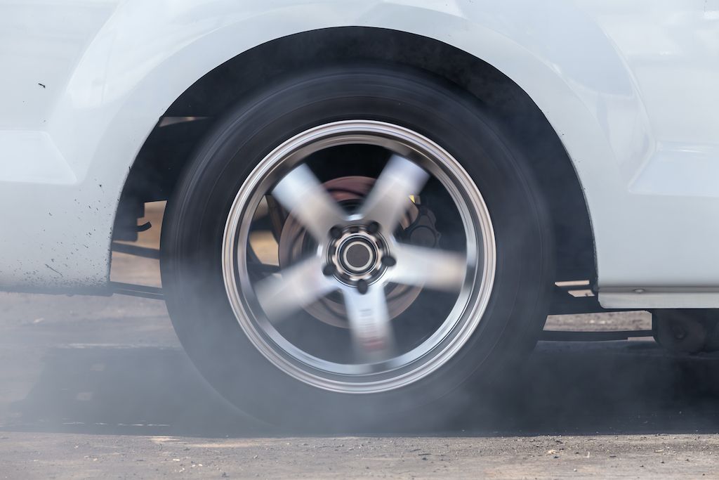 car-wheel-with-smoke-on-the-asphalt-road.jpg