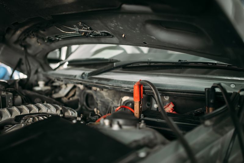 car-with-opened-hood-wire-for-battery-recharging.jpg