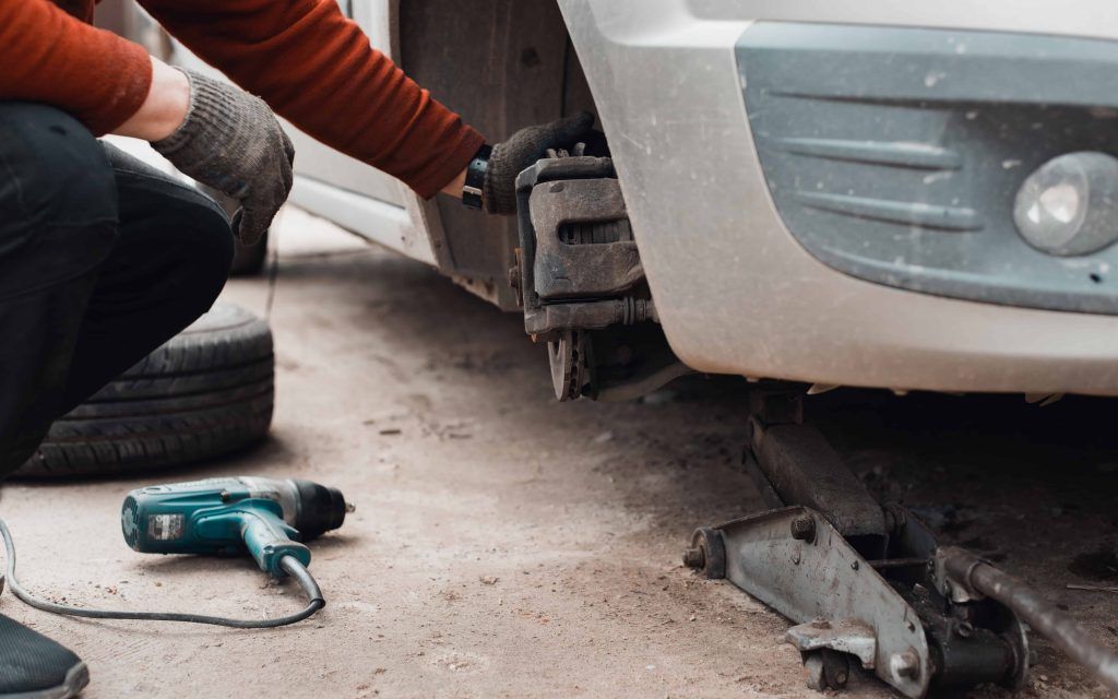 close-up-of-person-repairing-car-brake-1024x640.jpg