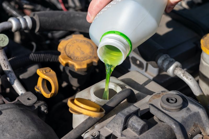 hand-with-bottle-pouring-antifreeze-coolant.jpg