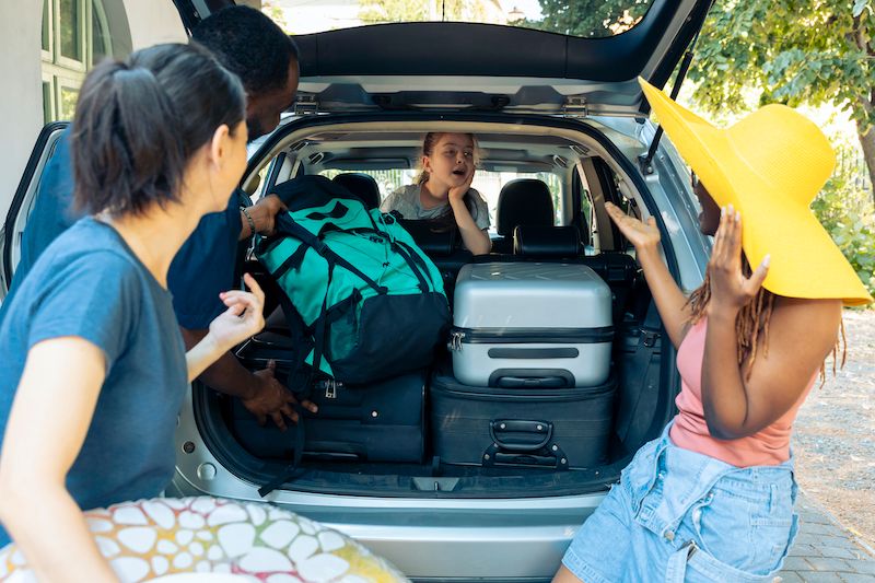 little-girl-and-diverse-people-going-on-vacation-in-packed-car.jpg