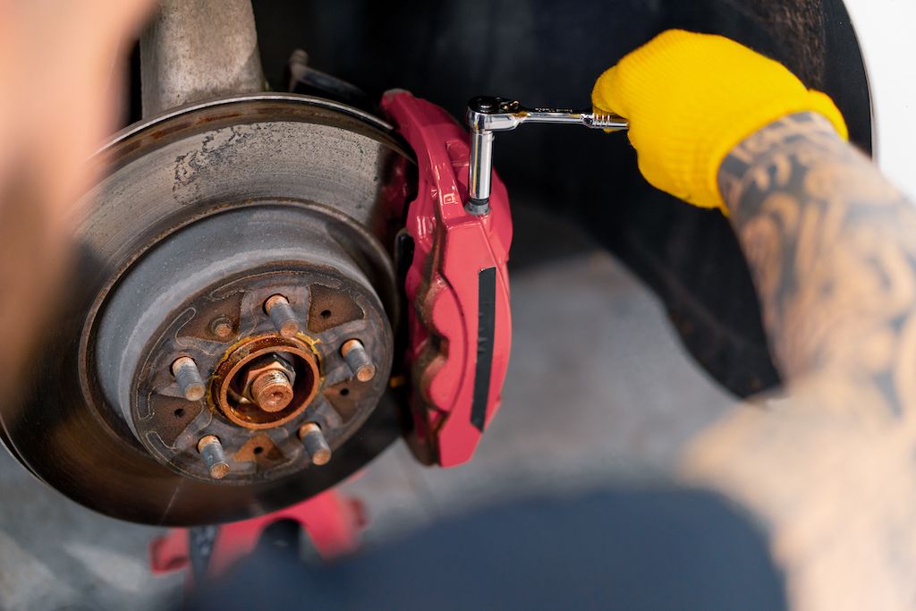 man-auto-mechanic-changing-brake-discs-on-a-car.jpg