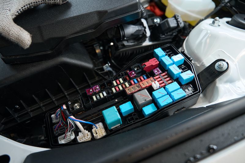 man-checking-details-of-car-electric-system.jpg