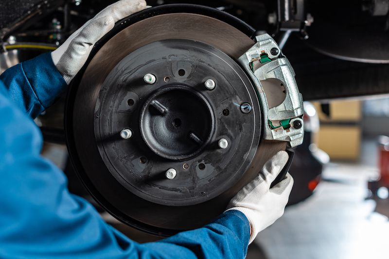 mechanic-adjusting-assembled-brake-disc.jpg