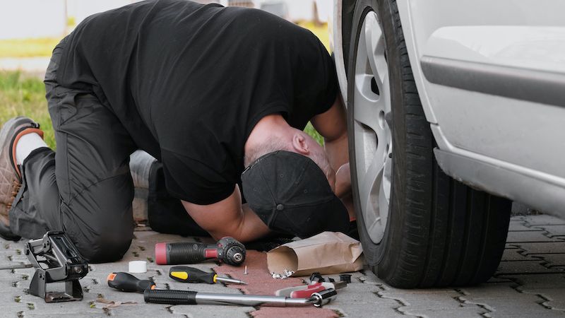 mechanic-repairs-car-working-on-suspension.jpg