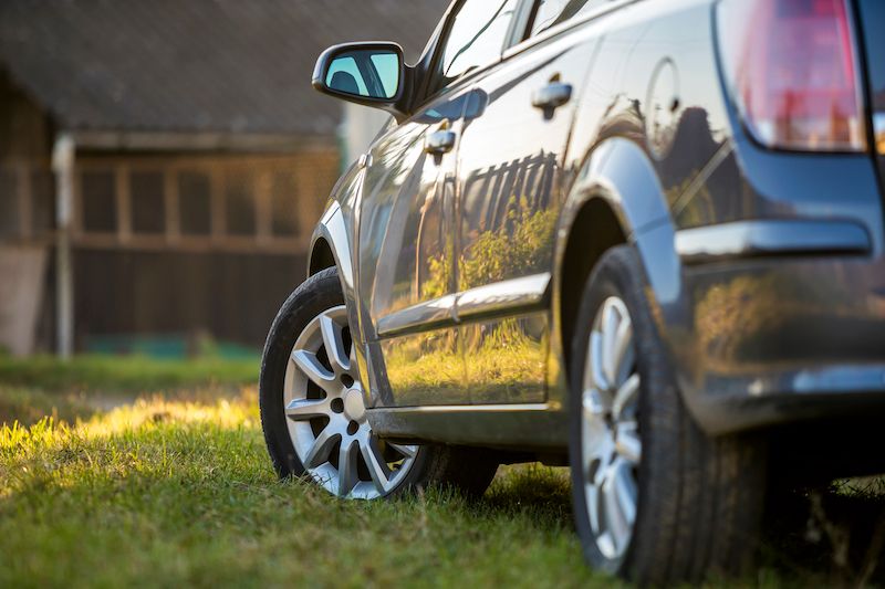 new-shiny-gray-car-parked-on-green-grass.jpg