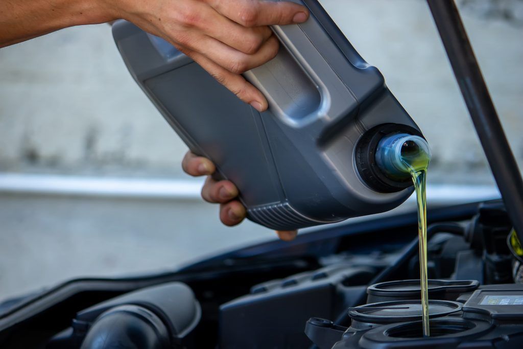 person-changing-oil-pours-oil-into-a-car-1024x683.jpg