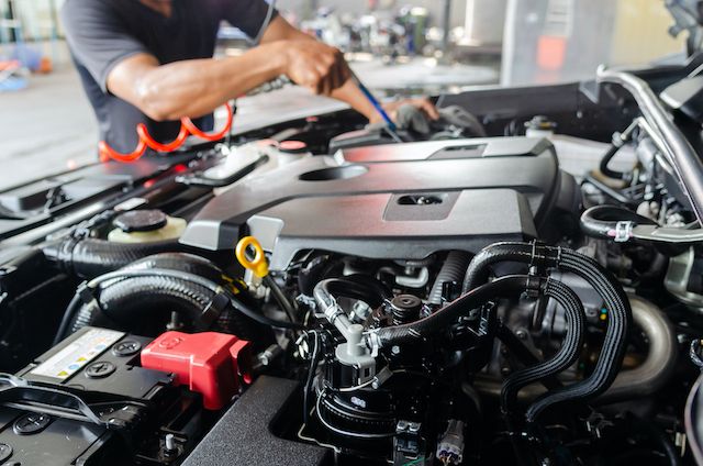 process-of-cleaning-the-engine-of-a-car-with-a-spray.jpg