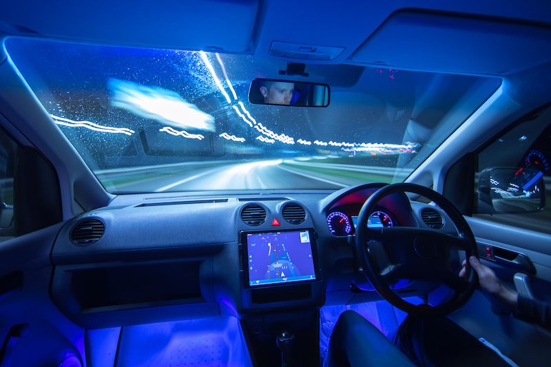 the-man-drive-a-car-with-a-gps-in-a-city-evening.jpg