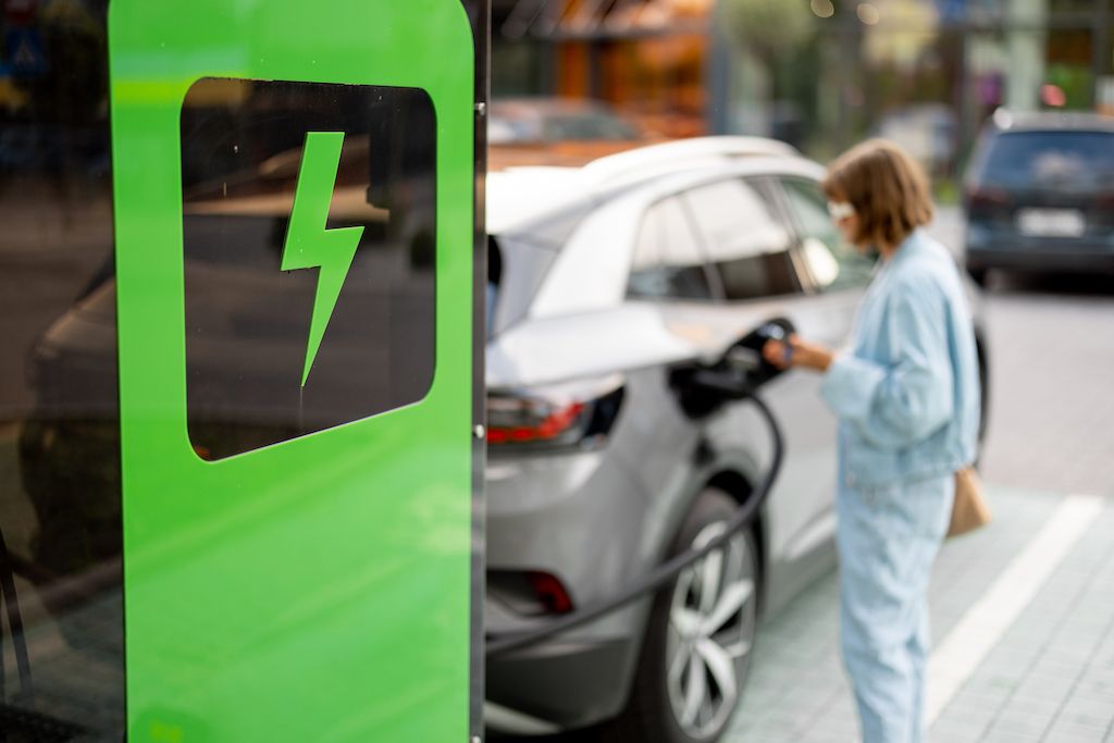 woman-charging-her-car-on-public-fast-charger.jpg