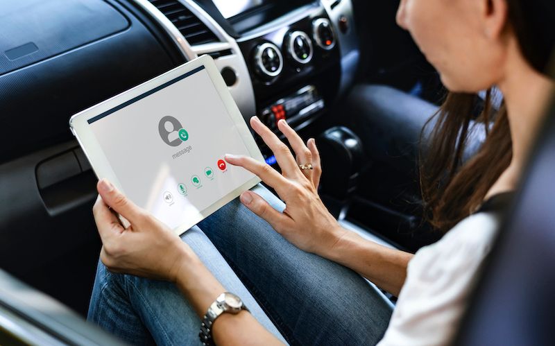 woman-using-a-digital-tablet-in-the-car.jpg