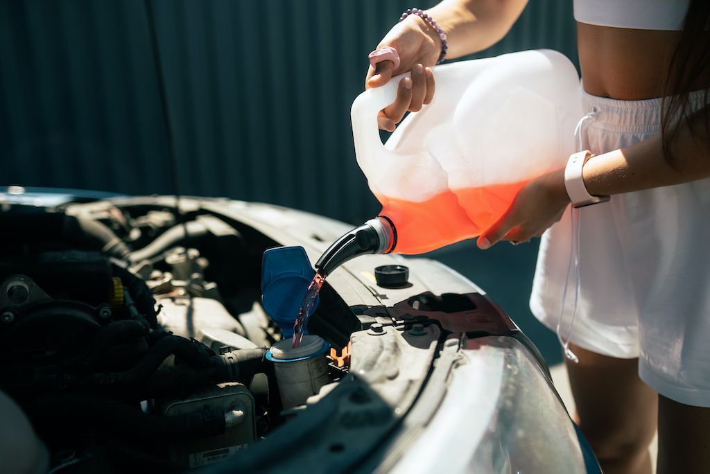 young-woman-pouring-antifreeze-car-screen-wash-liquid.jpg